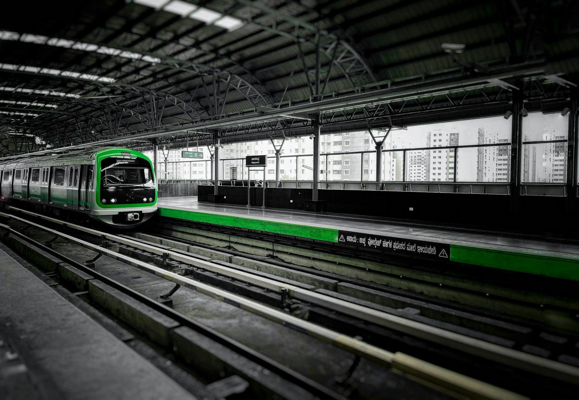 Modern metro train arriving at an elevated station platform, similar to Hopefarm Channasandra metro