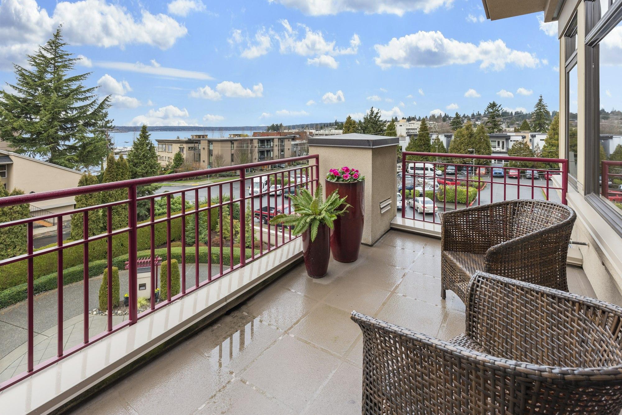 Shaded apartment balcony seating overlooking landscaped greens